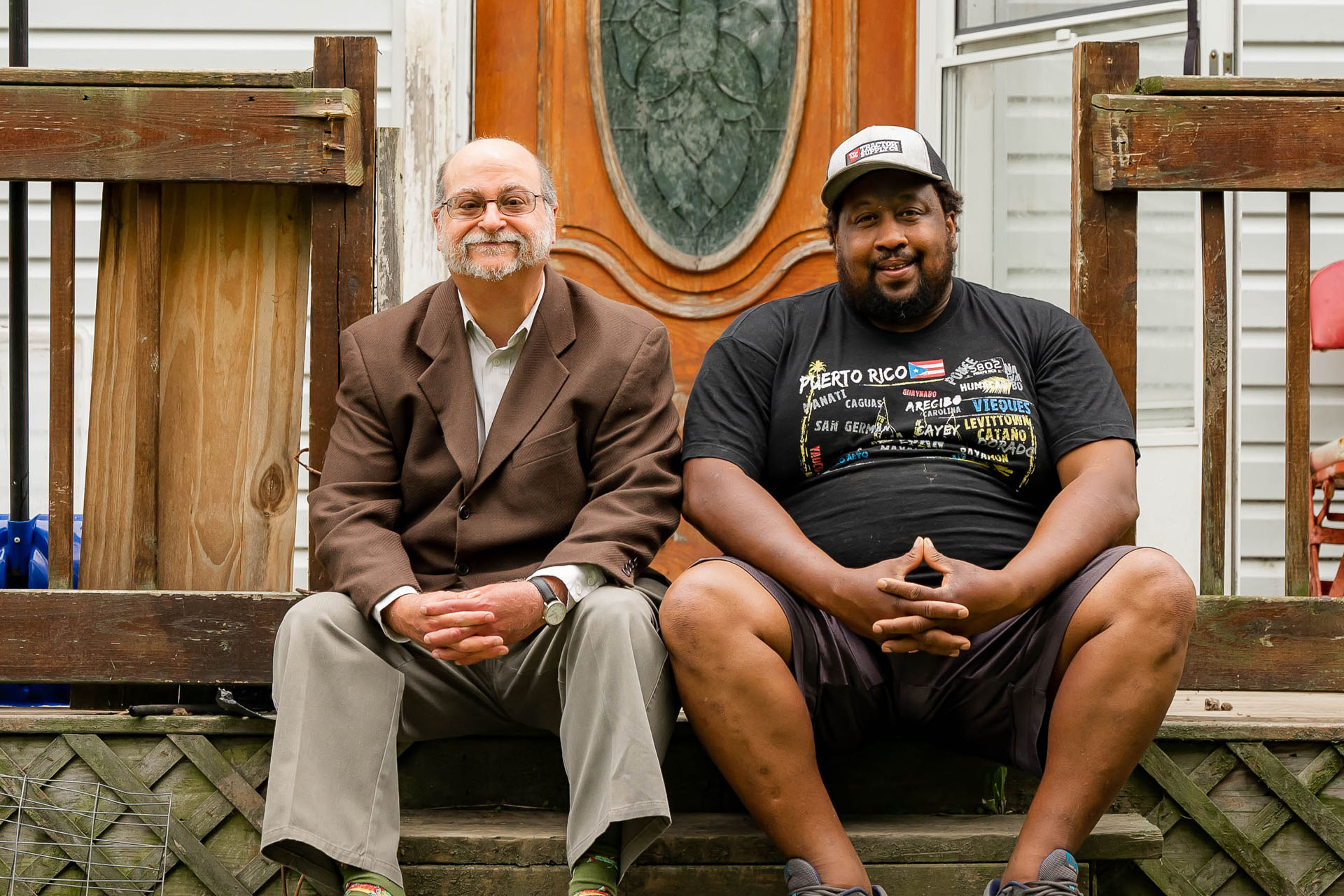 Two people sitting on a porch step